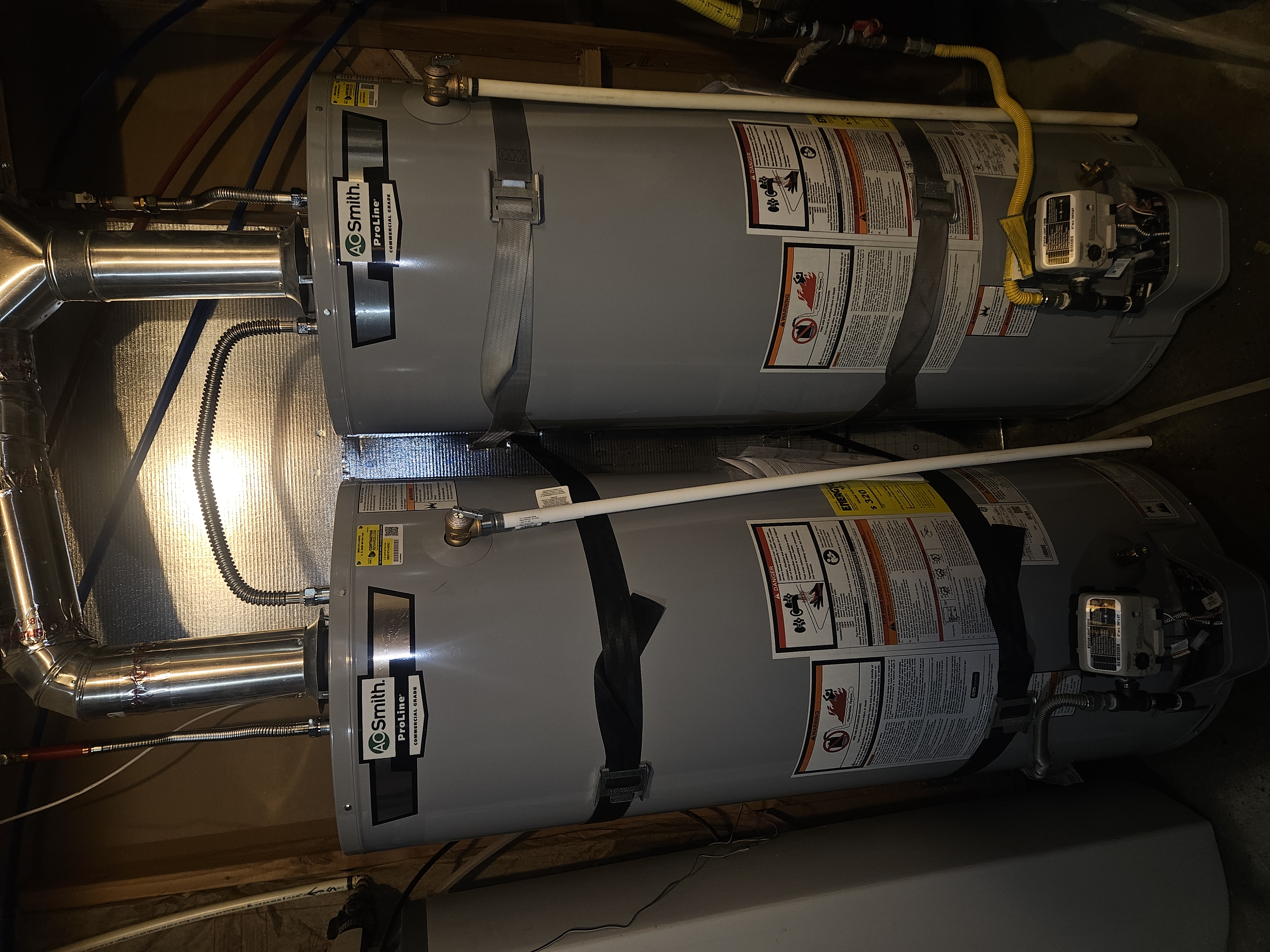 Two A.O. Smith ProLine 50-gallon gas water heaters installed side by side in American Fork, Utah