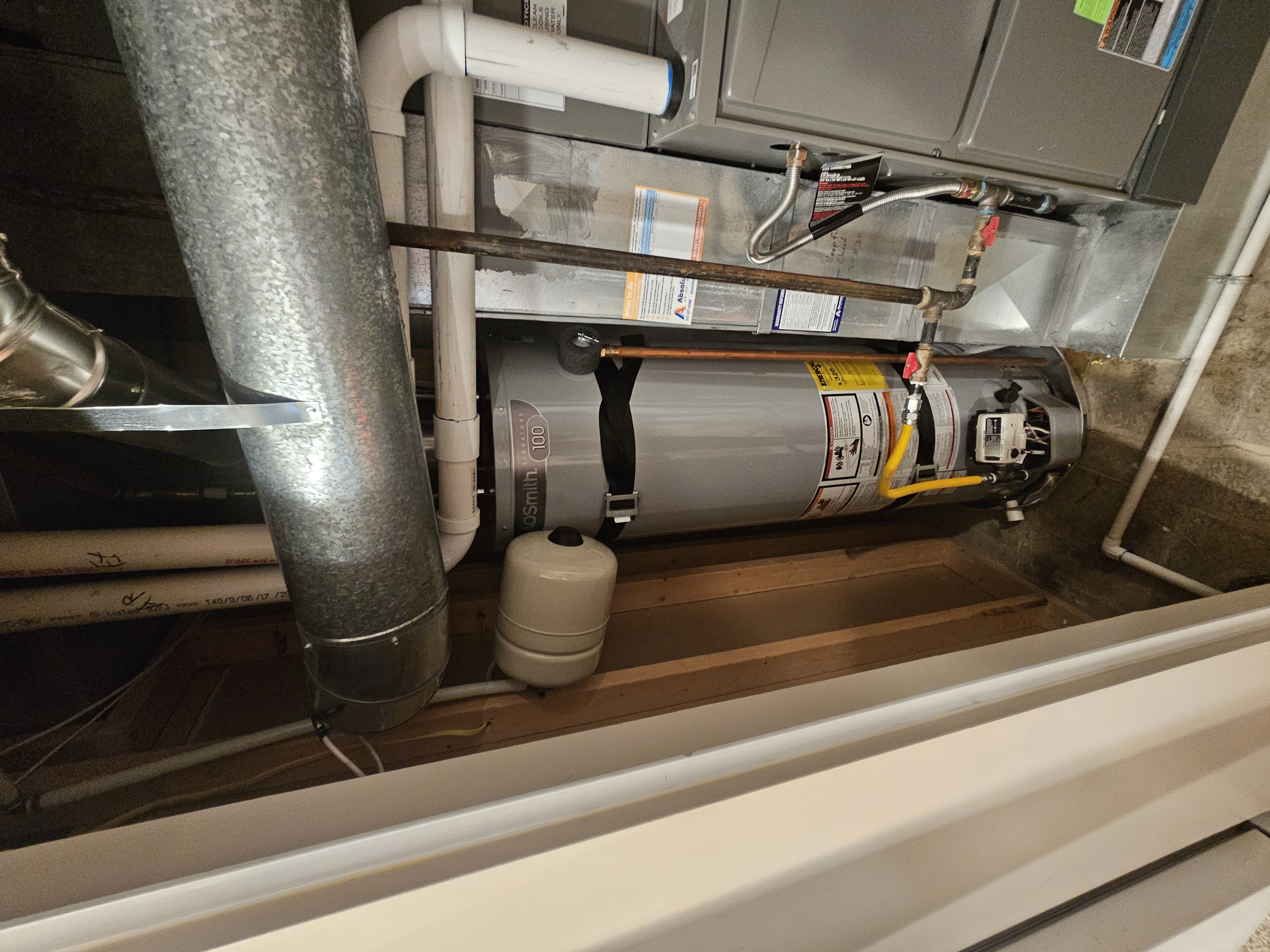 A.O. Smith narrow 18-inch water heater installed in a tight utility closet in Sandy, Utah